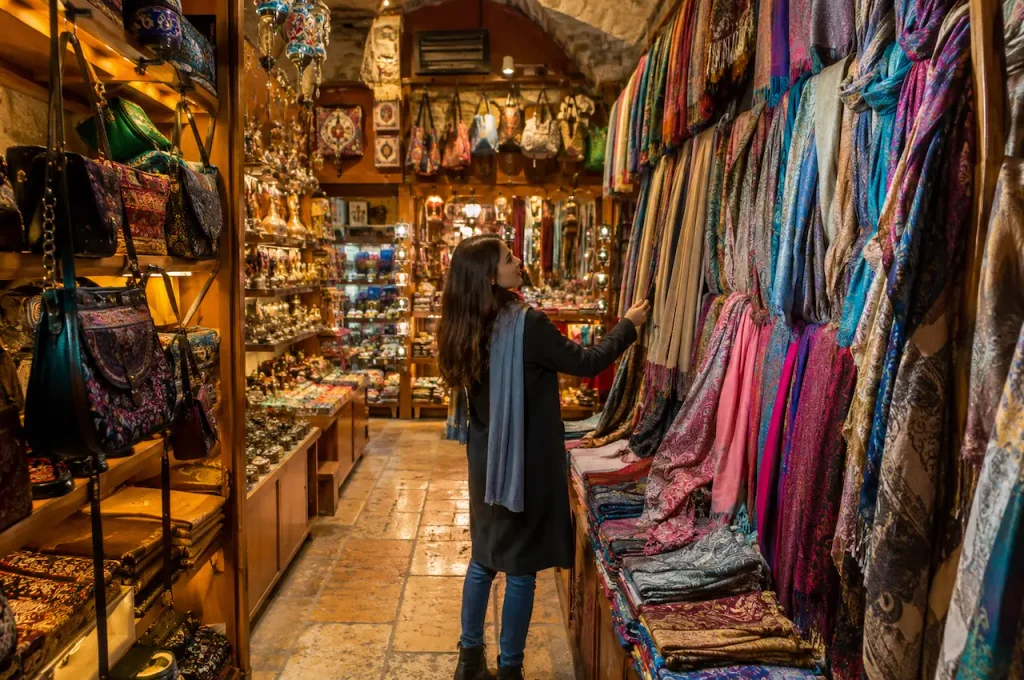 Woman browsing colourful scarves and souvenirs in Antalya’s Kaleiçi Old Town.