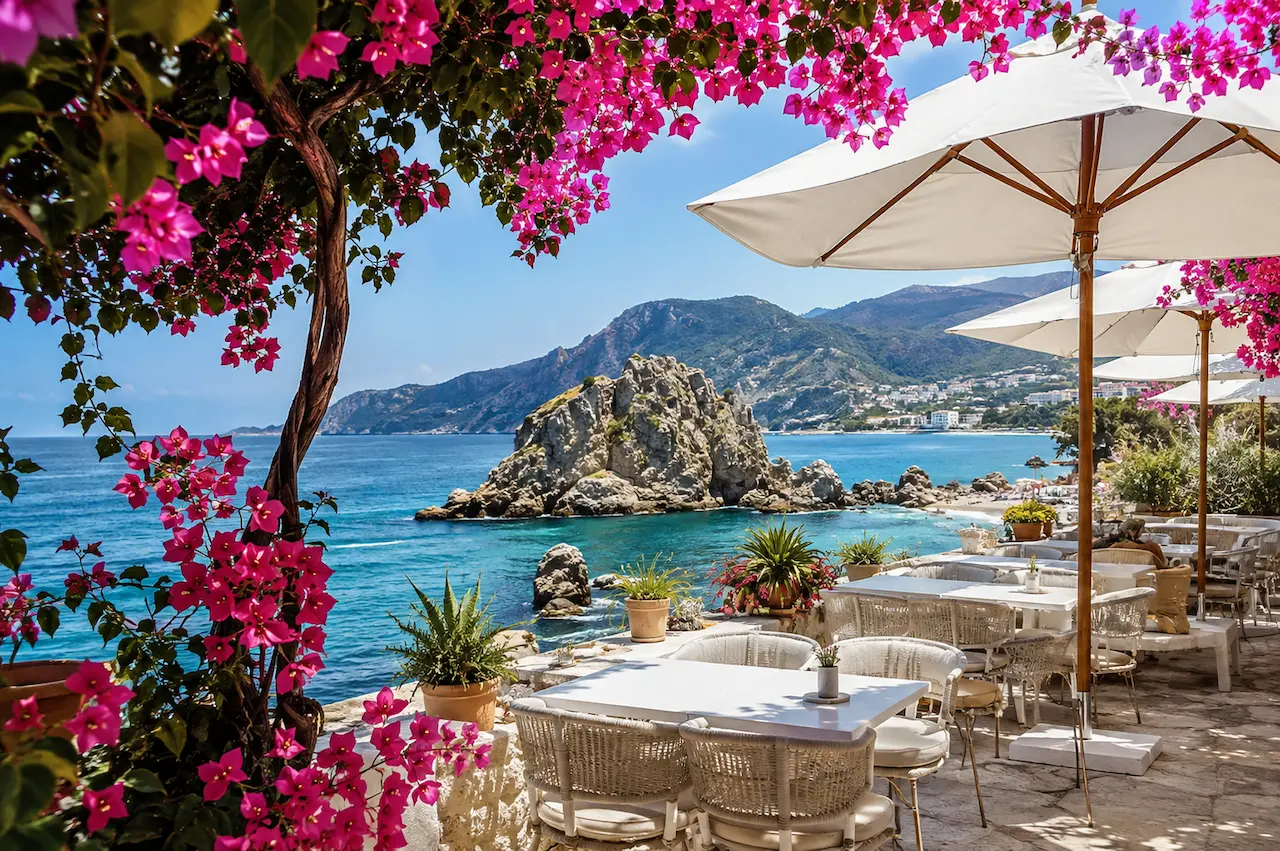 Seafront restaurant terrace overlooking a turquoise rocky bay on the Antalya coast.