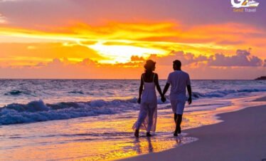 Romantic couple walking on a tropical beach during sunset in Thailand honeymoon holiday scene