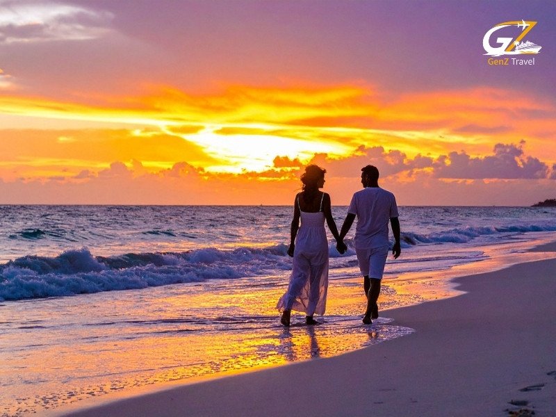 Romantic couple walking on a tropical beach during sunset in Thailand honeymoon holiday scene