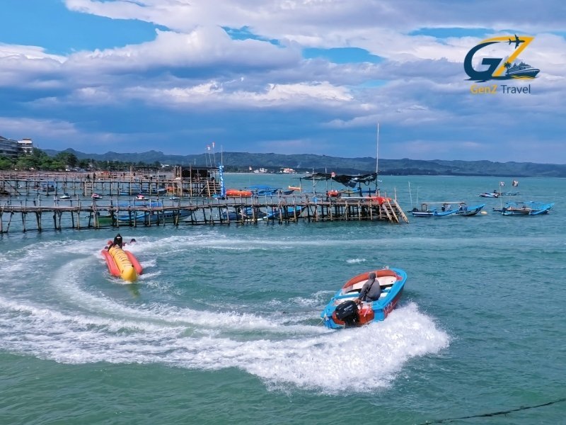 Speedboat traveling across turquoise ocean waters toward Phi Phi Islands on a sunny day