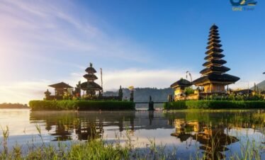 Traditional Balinese temple near tropical waterfall surrounded by jungle