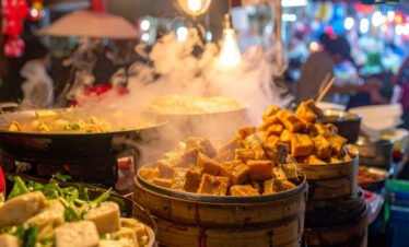 Vibrant Bangkok street food market at night with colorful lights and authentic Thai cuisine stalls