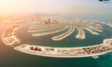 Palm Jumeirah Dubai skyline sunset view with luxury hotels and Arabian Gulf coastline