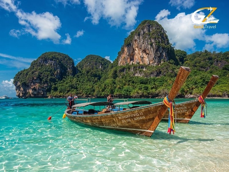 Krabi limestone cliffs with longtail boats and turquoise water Thailand