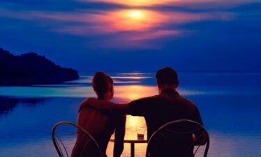Couple walking on Maldives beach at sunset romantic luxury holiday