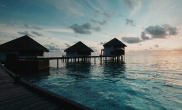 Overwater villa in Maldives with turquoise lagoon and luxury deck