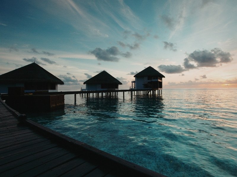 Overwater villa in Maldives with turquoise lagoon and luxury deck