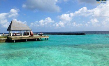 Overwater villas in the Maldives with turquoise lagoon and clear sky