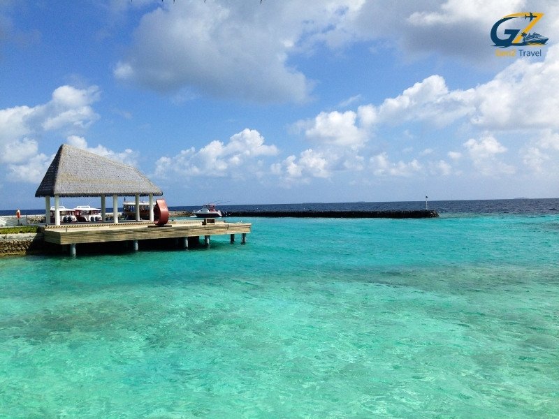Overwater villas in the Maldives with turquoise lagoon and clear sky