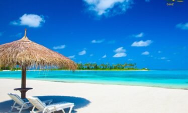 tropical Maldives sandbank surrounded by clear blue ocean under bright sunny sky