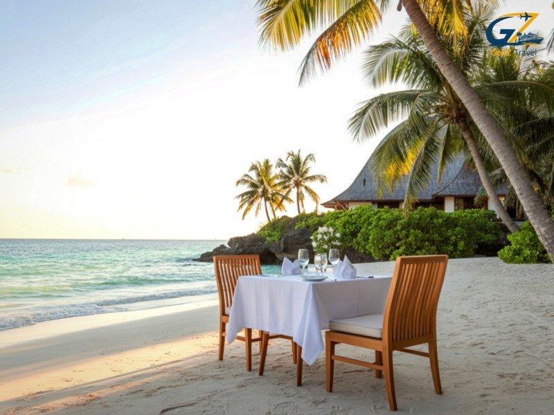Romantic sunset dinner setup on Maldives beach for honeymoon couples