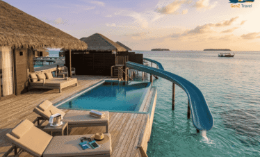 Maldives water villa with private pool and slide at Siyam World resort over turquoise lagoon