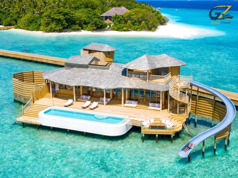 Maldives water villa with private pool and slide at Siyam World over clear lagoon