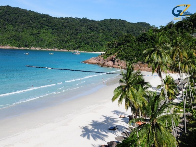 Beachfront luxury resort in Pattaya with calm ocean waves and tropical palm trees at sunset