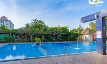 Ramada Resort Lara Antalya pool area with sun loungers and all inclusive facilities
