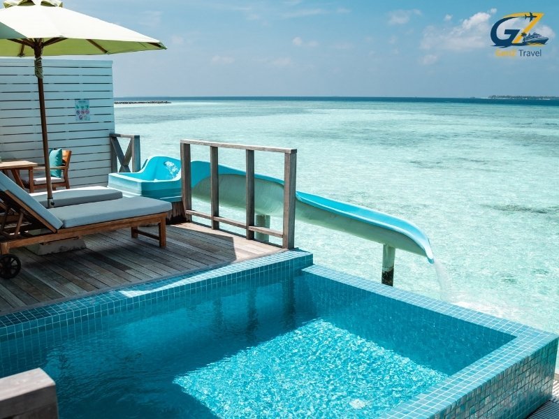 Siyam World Maldives water villa with private pool and slide into turquoise lagoon