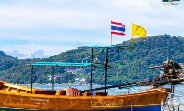 Speed boat crossing turquoise waters from Phuket to Koh Yao Noi island surrounded by limestone cliffs