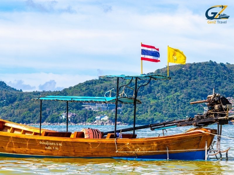 Speed boat crossing turquoise waters from Phuket to Koh Yao Noi island surrounded by limestone cliffs