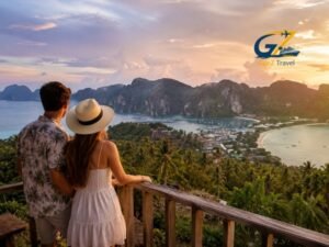 Romantic couple watching sunset over Thailand tropical islands from a scenic mountain viewpoint surrounded by lush greenery and ocean views