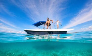 Travellers enjoying a Maldives boat trip and water activity in clear turquoise lagoon waters.