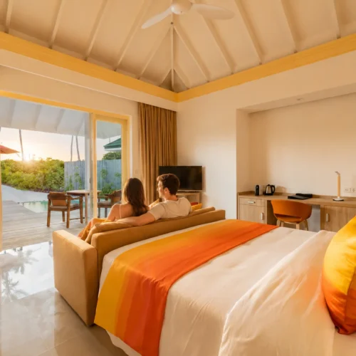 UK couple relaxing on sun loungers beside a private pool at Siyam World Maldives Sunset Pool Beach Villa