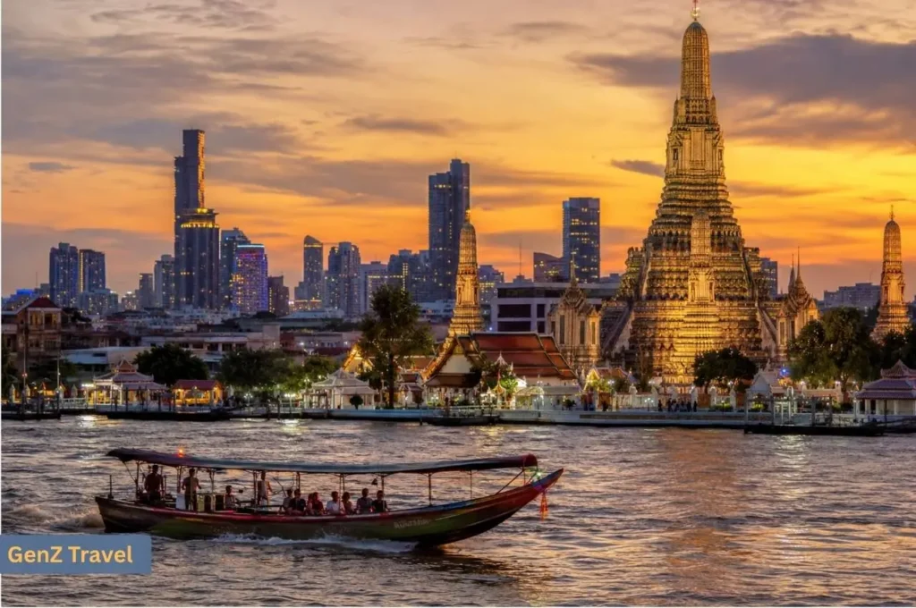 Wat Arun beside the Chao Phraya River with Bangkok’s skyline at sunset