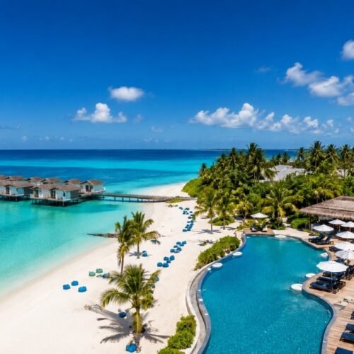 Oblu Xperience Ailafushi resort with turquoise lagoon, overwater villas, white-sand beach and beachfront swimming pool in the Maldives.