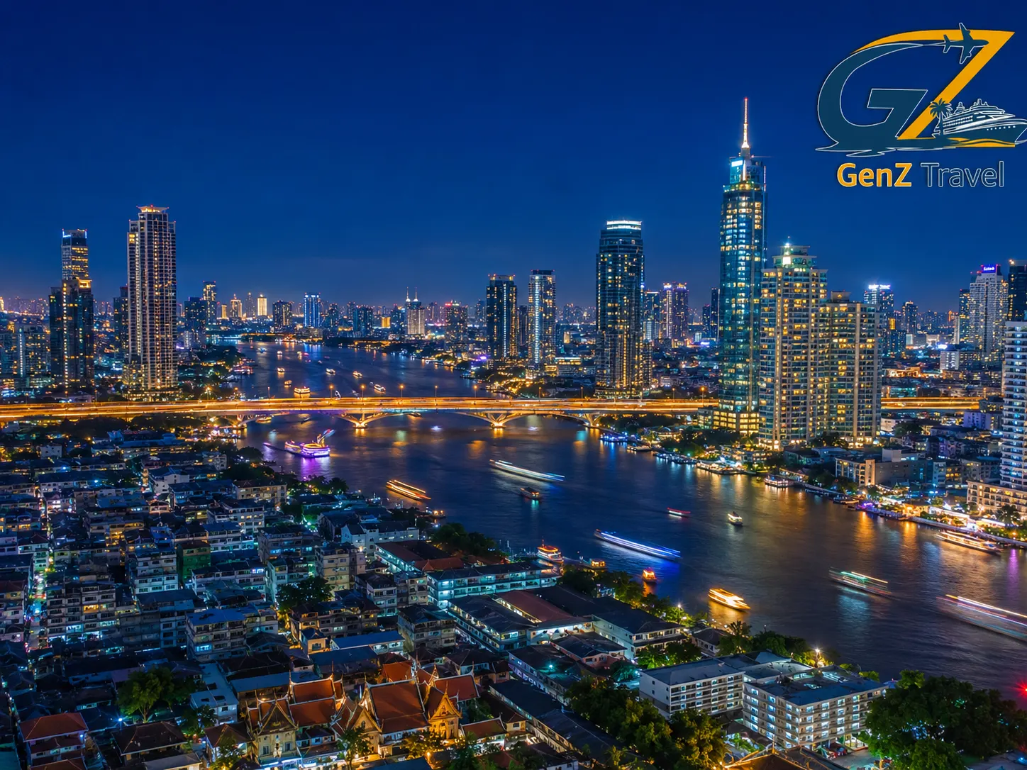 Aerial night view of Bangkok skyline and Chao Phraya River lined with illuminated skyscrapers