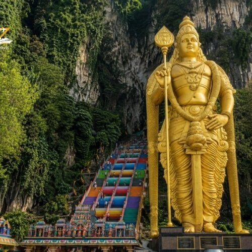 Batu Caves in Kuala Lumpur with the golden Murugan statue and colourful temple steps