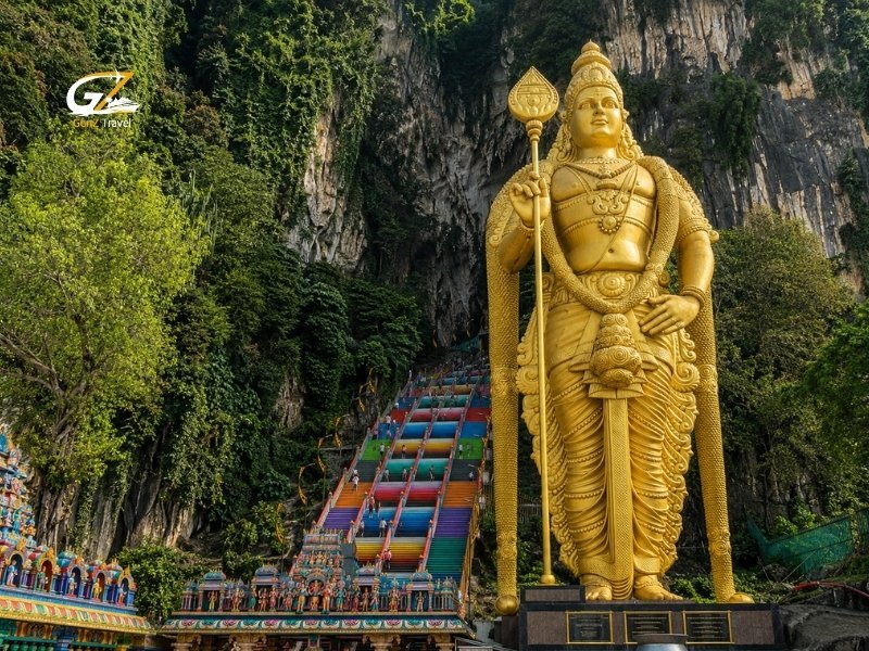 Batu Caves in Kuala Lumpur with the golden Murugan statue and colourful temple steps