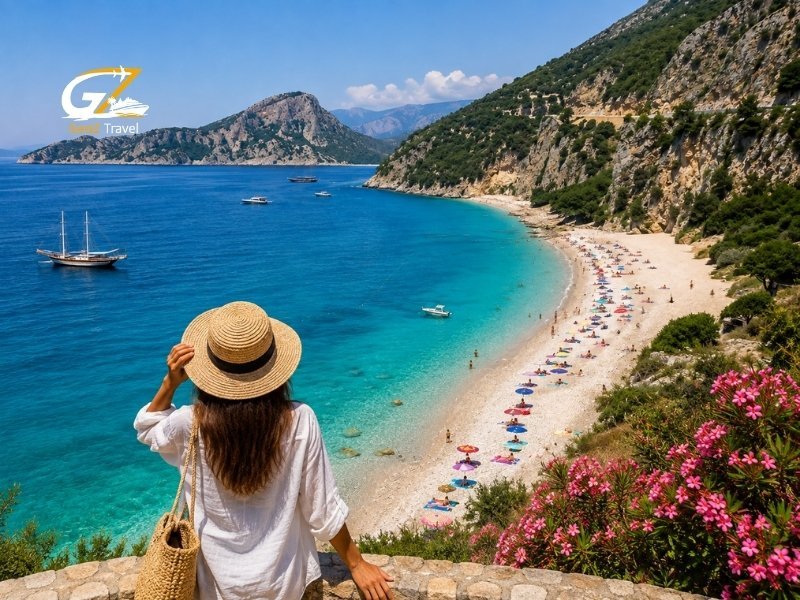 Best beaches in Turkey with a female traveller overlooking a turquoise coastal bay and mountain scenery