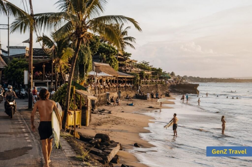 Surfers walking along Canggu Beach beside cafés and palm trees in Bali