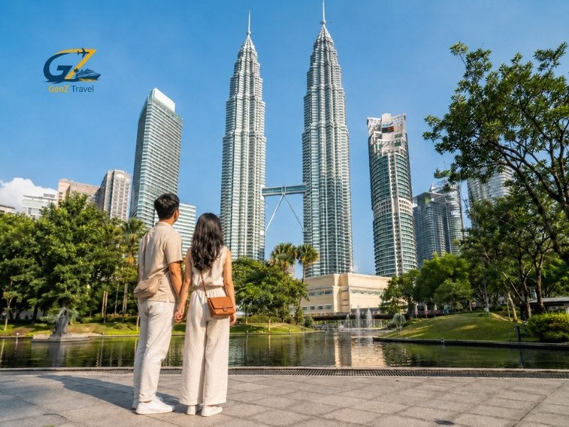 Couple on Malaysia holidays visiting the Petronas Twin Towers in Kuala Lumpur