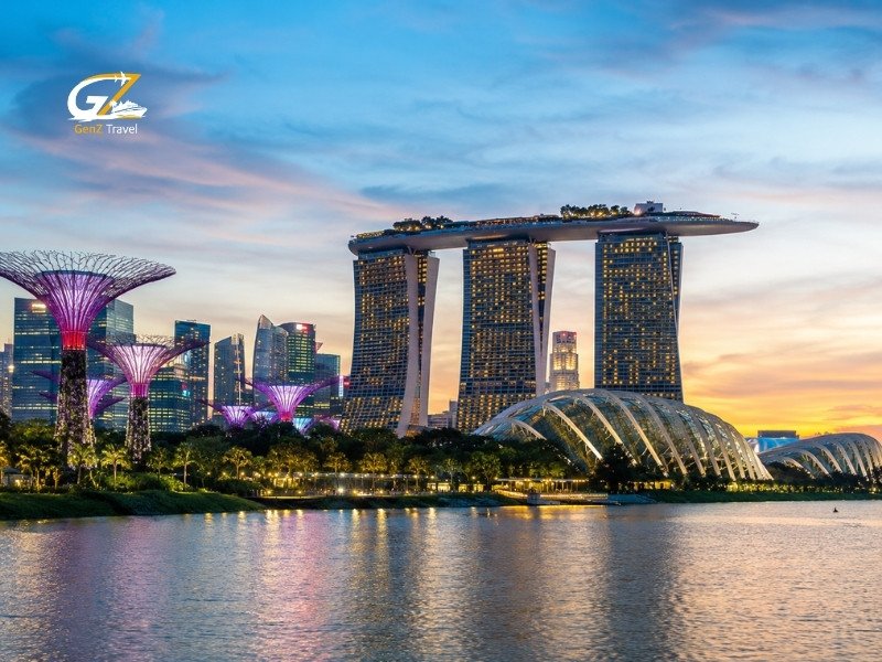 Marina Bay Sands and Gardens by the Bay illuminated at sunset across Singapore’s waterfront