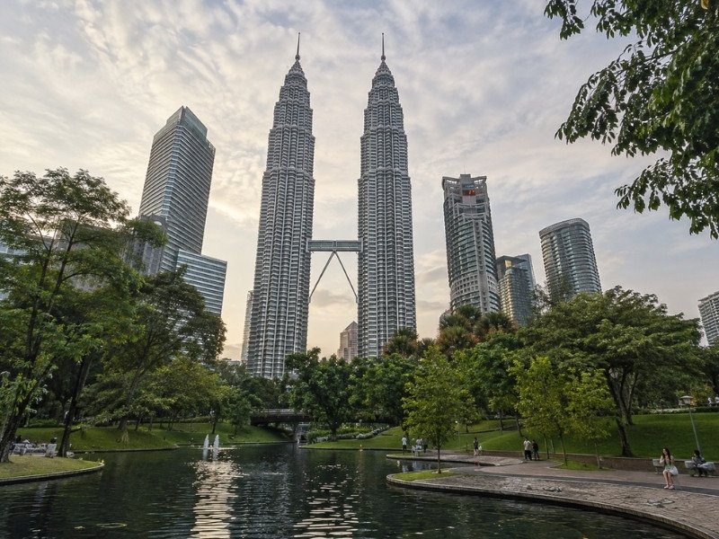 Petronas Twin Towers overlooking KLCC Park and its reflective lake in Kuala Lumpur