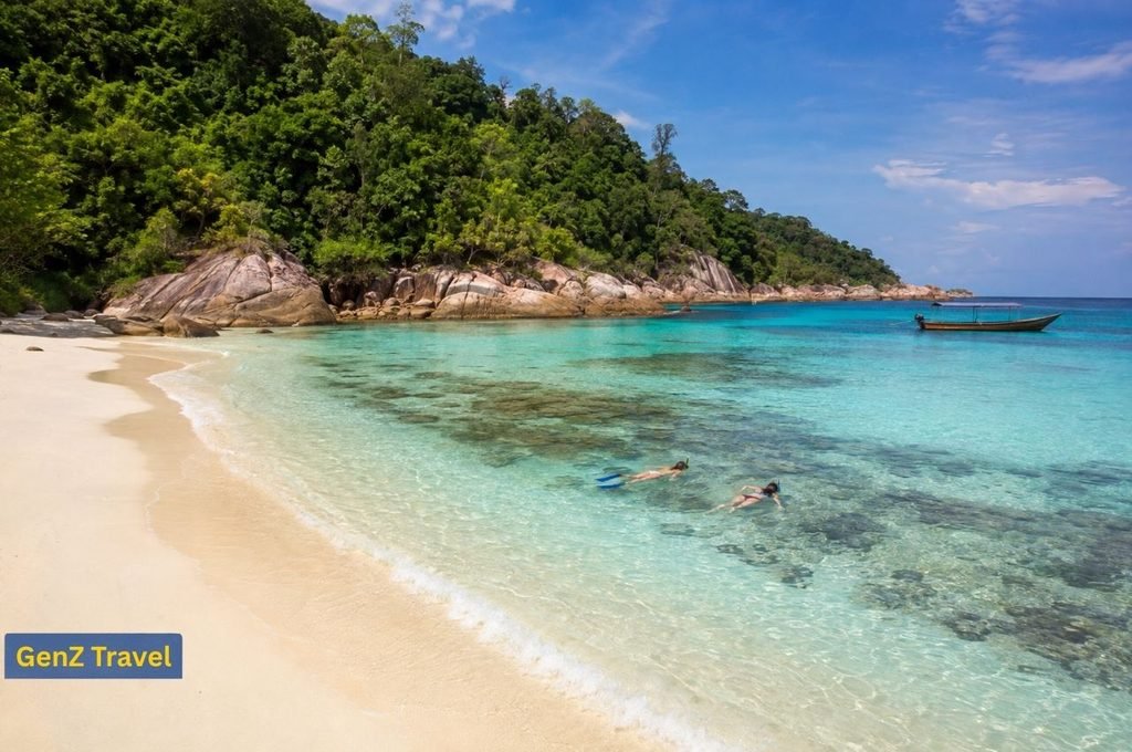 Snorkellers exploring clear coral waters beside Redang Island, Malaysia