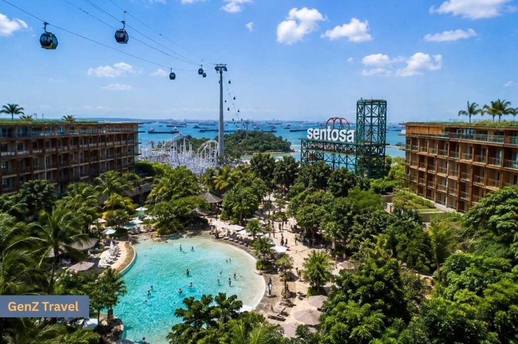 Aerial view of Sentosa Island resort hotels, tropical swimming pool, cable cars and family attractions.