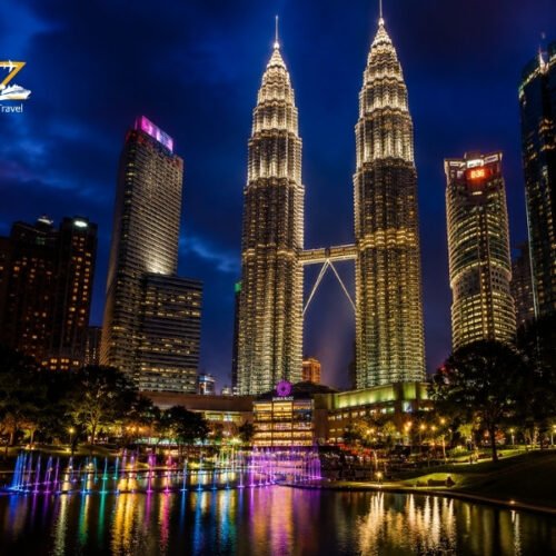 Kuala Lumpur skyline at night with illuminated Petronas Twin Towers and fountain reflections