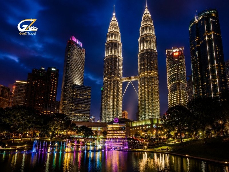Kuala Lumpur skyline at night with illuminated Petronas Twin Towers and fountain reflections