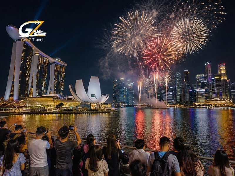 New year celebration in Singapore with fireworks over Marina Bay Sands and crowds watching from the waterfront
