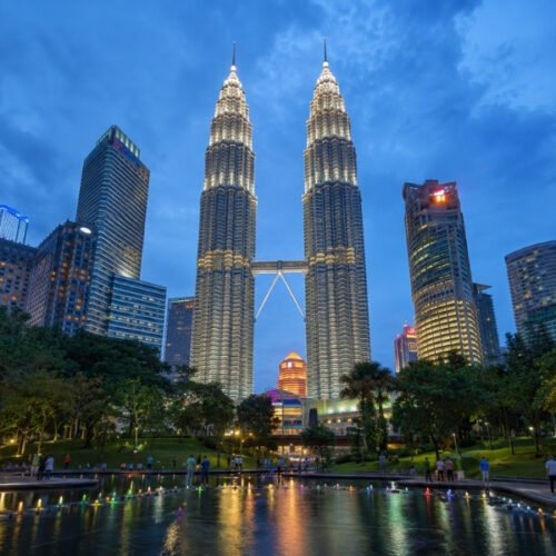 Petronas Twin Towers Kuala Lumpur illuminated at night with city lights and reflections