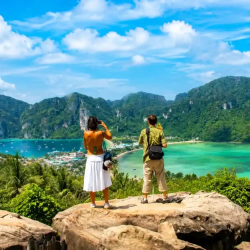 Aerial sunset view of Phi Phi Islands with turquoise sea, tropical forest and beach resorts in Thailand