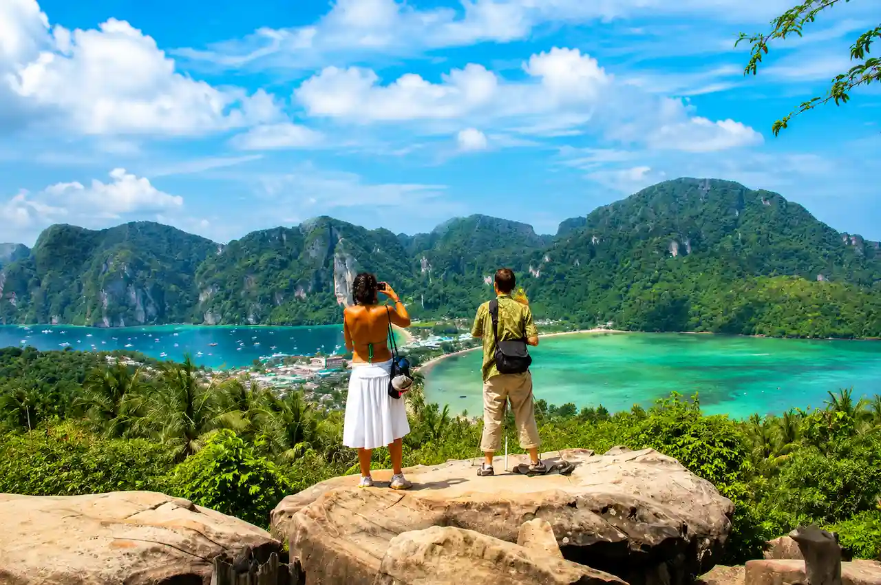 Aerial sunset view of Phi Phi Islands with turquoise sea, tropical forest and beach resorts in Thailand