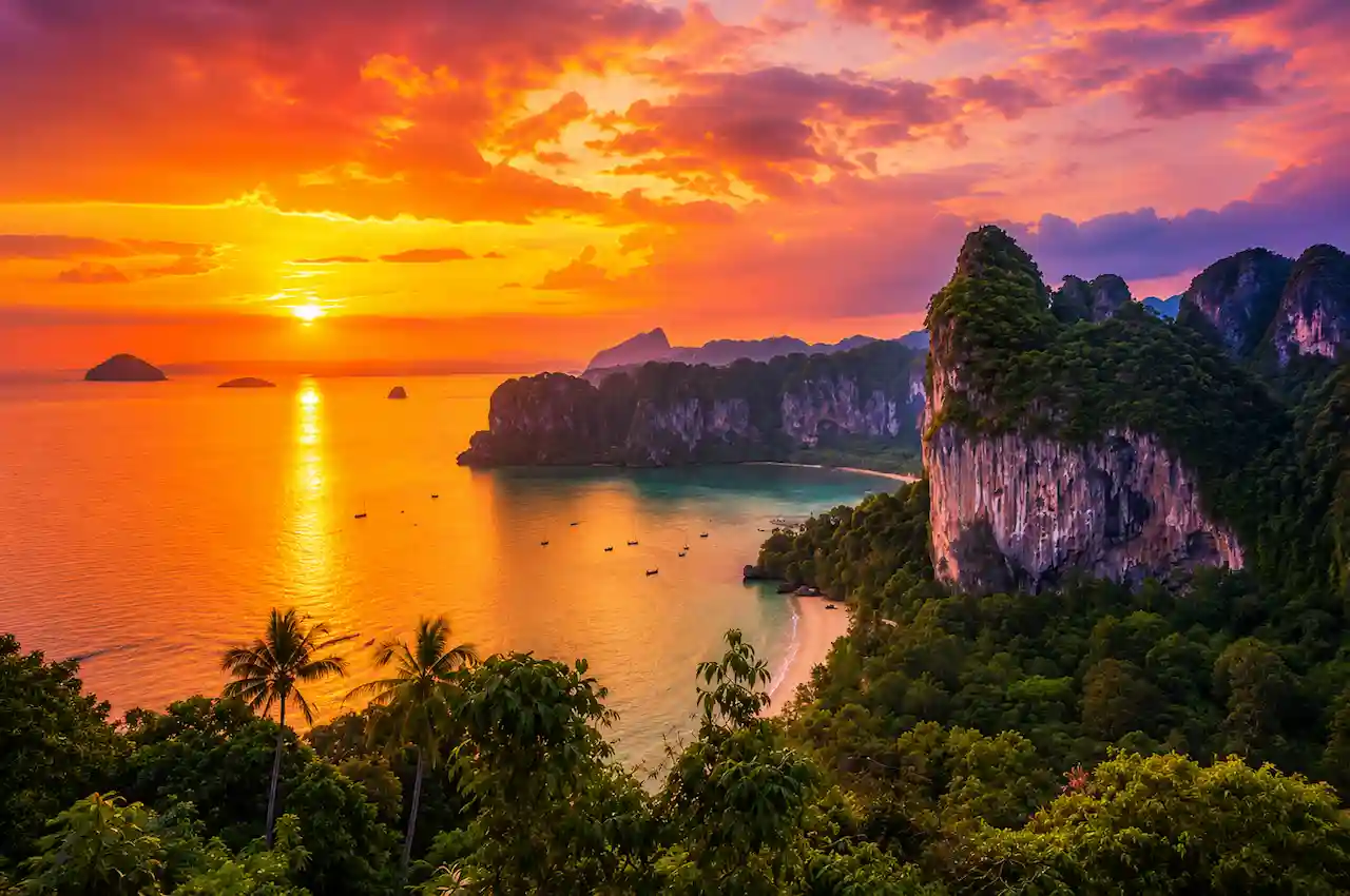 Traveller enjoying a longtail boat journey through Phi Phi Islands with turquoise water and limestone cliffs in Thailand