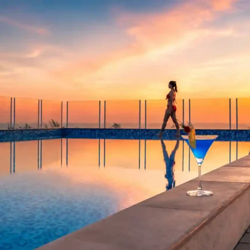 Modern Phuket resort pool area illuminated in the evening with a tropical sunset atmosphere