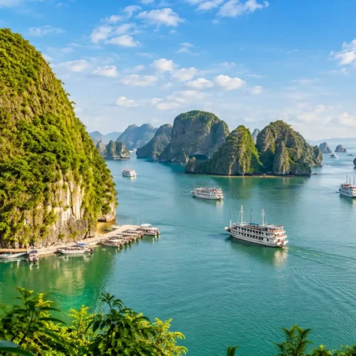 Scenic view of Ha Long Bay with emerald water, limestone islands and cruise boats during a Vietnam holiday