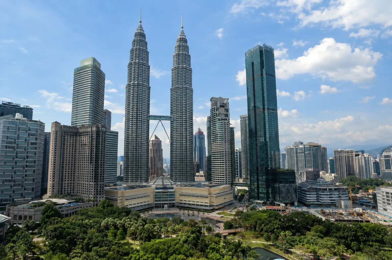 Kuala Lumpur skyline featuring the famous Petronas Twin Towers, modern skyscrapers and green city surroundings in Malaysia.