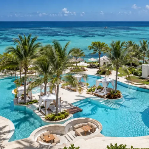 Luxury Zanzibar beach resort with a turquoise swimming pool, private cabanas, palm trees and beautiful Indian Ocean views.